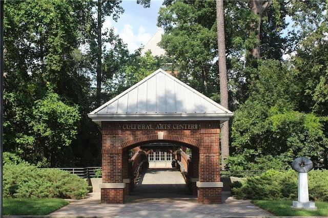 surrounding community with fence, asphalt driveway, and a garage