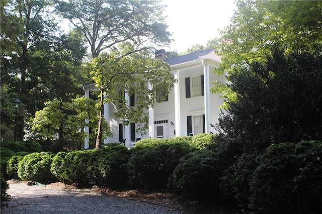 view of property exterior featuring a chimney