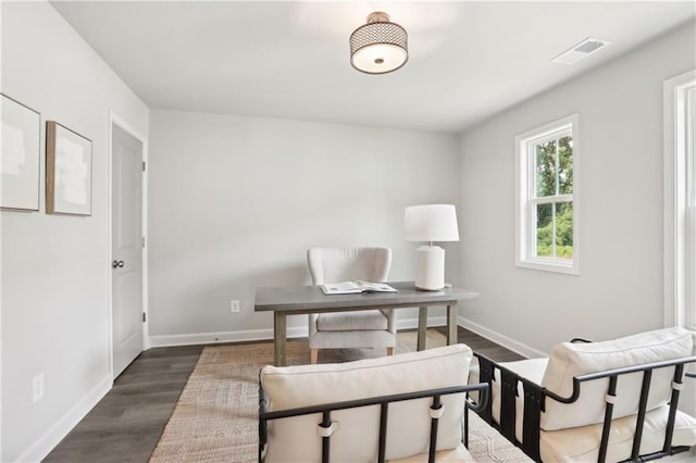 office space with visible vents, baseboards, and wood finished floors