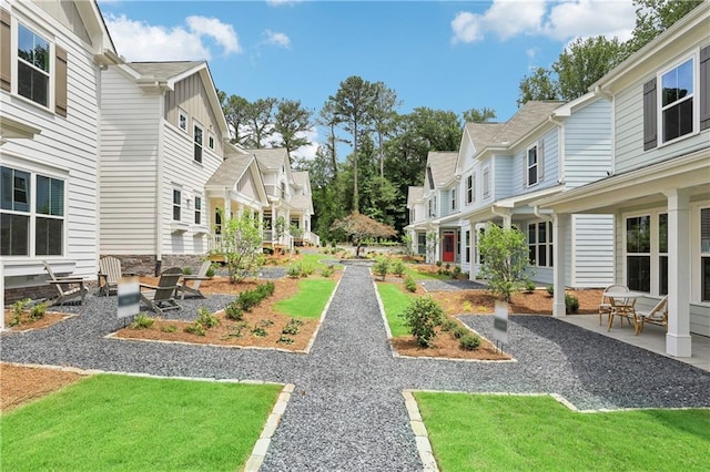 view of home's community with a residential view and a patio