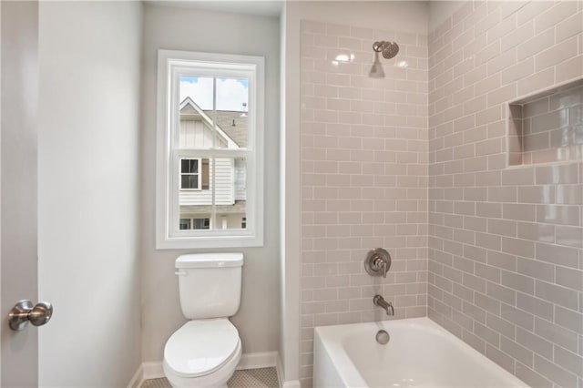 full bathroom with  shower combination, baseboards, and toilet