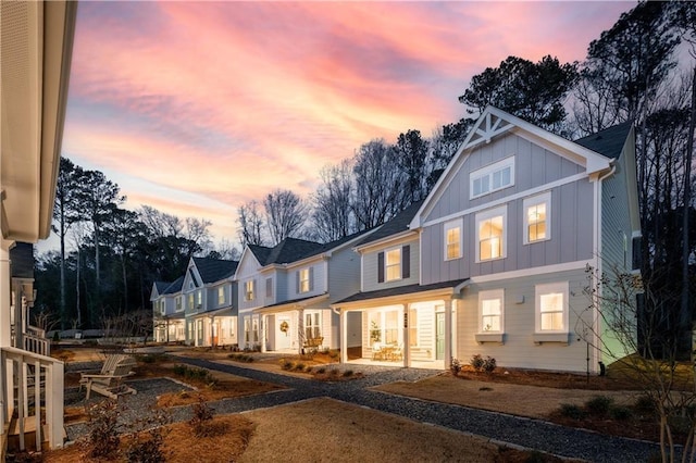 rear view of house with a residential view and board and batten siding