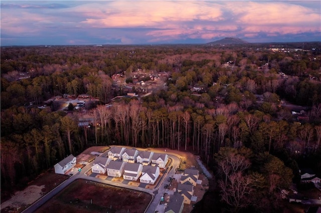 aerial view at dusk with a view of trees