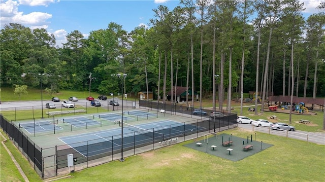 view of sport court with fence and a yard