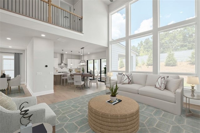 living room featuring a high ceiling and light hardwood / wood-style floors