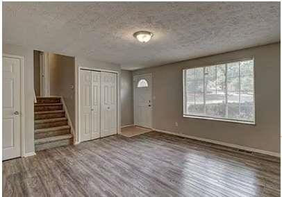 foyer entrance featuring hardwood / wood-style floors and a textured ceiling