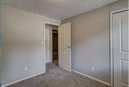 unfurnished bedroom featuring carpet floors and a textured ceiling