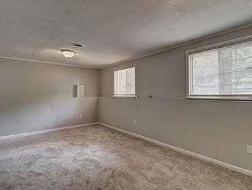 empty room featuring ornamental molding and light colored carpet