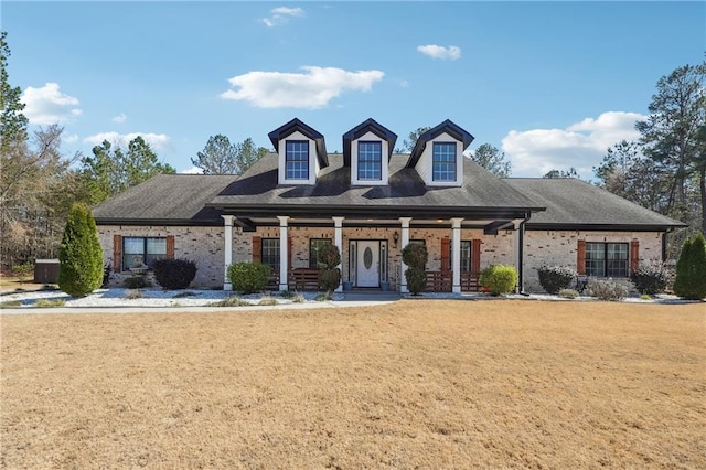 view of front of house with a front yard and brick siding