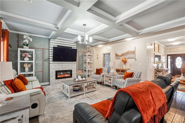 living area with a glass covered fireplace, beamed ceiling, and coffered ceiling