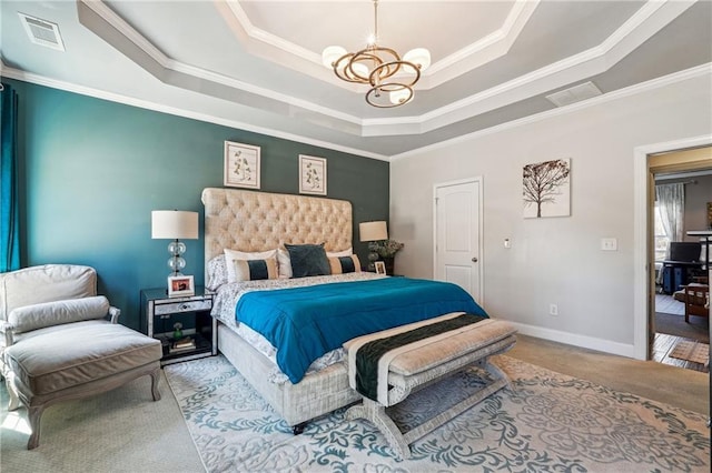 bedroom featuring a tray ceiling, visible vents, and a chandelier