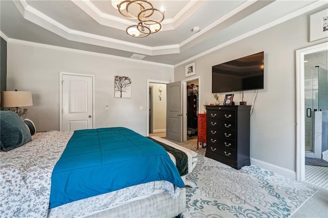 carpeted bedroom with a notable chandelier, ornamental molding, a tray ceiling, a closet, and baseboards