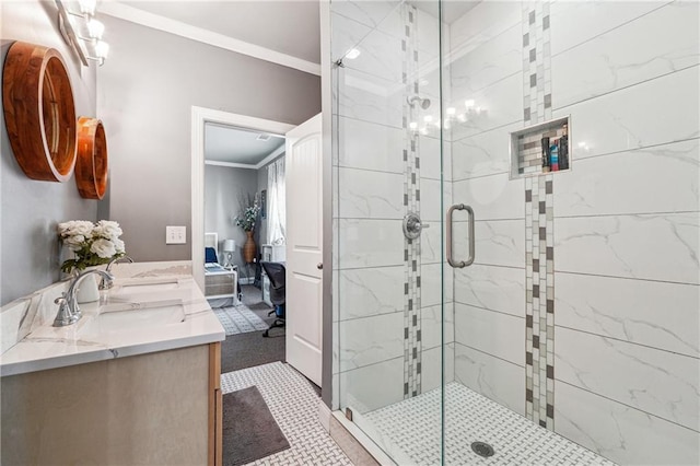 bathroom featuring double vanity, a sink, a shower stall, and ornamental molding