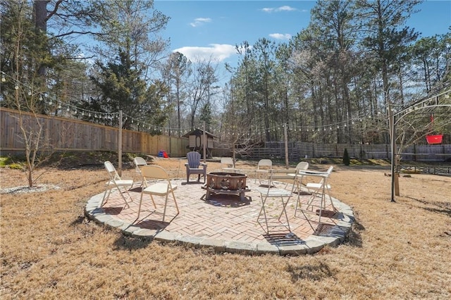 view of patio with a fenced backyard and an outdoor fire pit