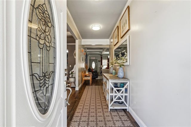 entryway featuring wood finished floors, baseboards, and ornamental molding