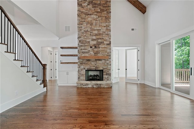 unfurnished living room featuring visible vents, baseboards, and dark wood-style flooring