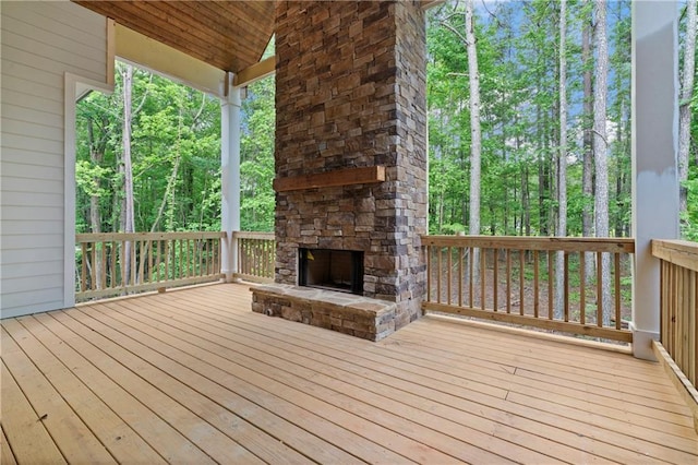 deck featuring an outdoor stone fireplace