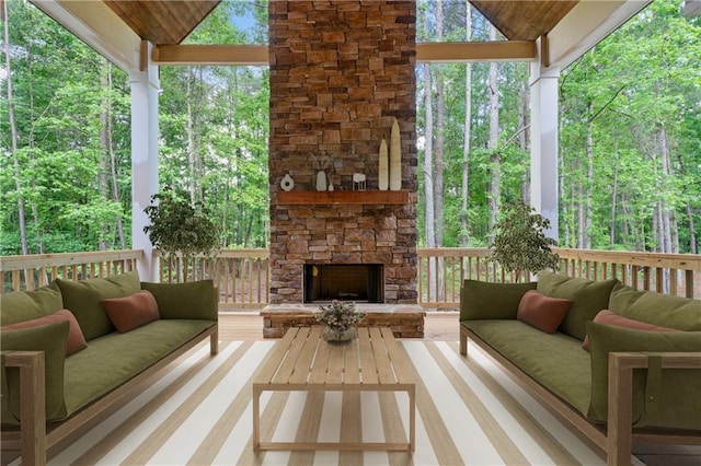 exterior space with a wooded view and an outdoor living space with a fireplace