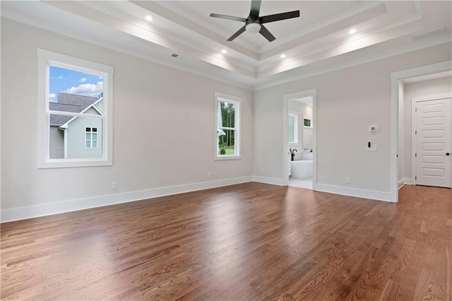 unfurnished room with ceiling fan, baseboards, a tray ceiling, recessed lighting, and wood finished floors