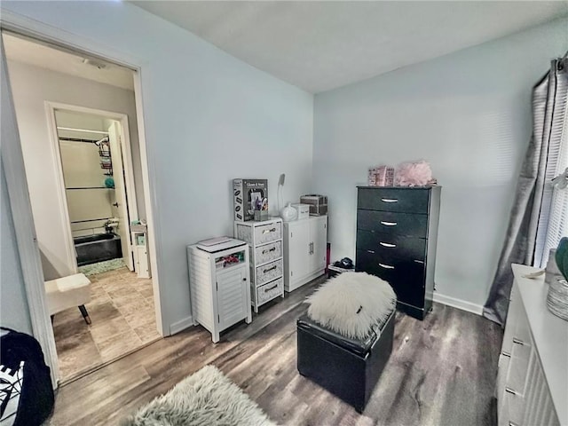 bedroom with dark hardwood / wood-style flooring