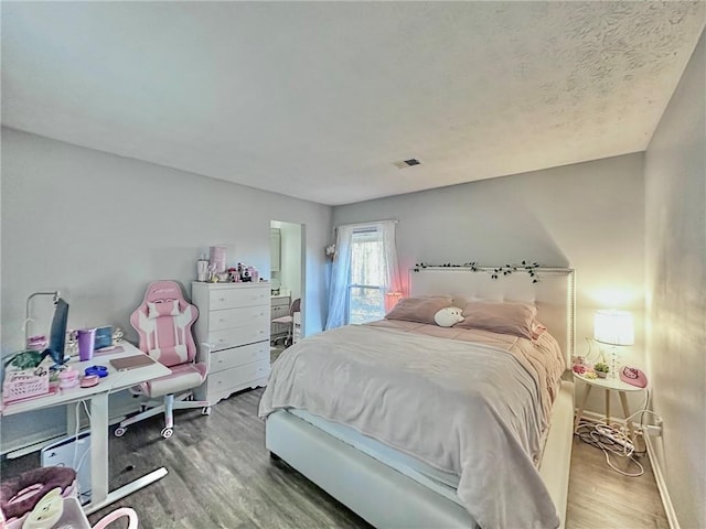 bedroom with hardwood / wood-style floors