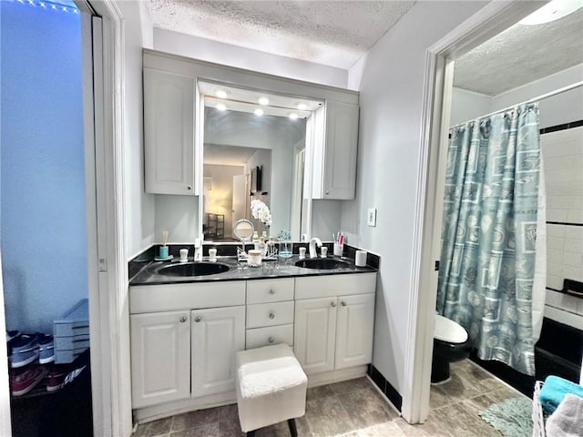 4359 Idlewood Ln, Tucker, GA 30084 - full bath with double vanity, a textured ceiling, shower / bath combo with shower curtain, and a sink