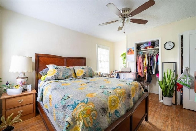 bedroom featuring wood-type flooring, ceiling fan, a textured ceiling, and a closet