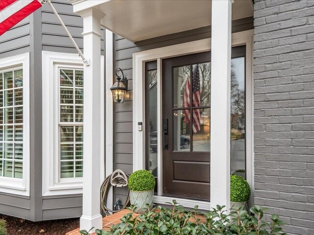 entrance to property featuring brick siding