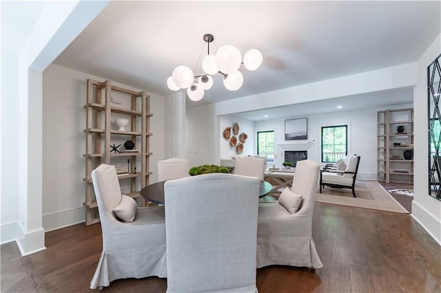 dining area featuring dark hardwood / wood-style flooring and a chandelier