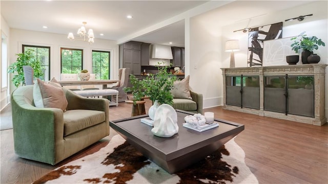 living room featuring a notable chandelier and hardwood / wood-style flooring