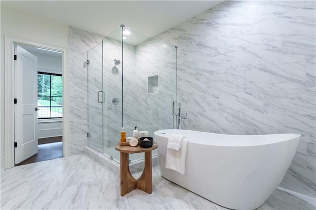 bathroom featuring tile walls and shower with separate bathtub