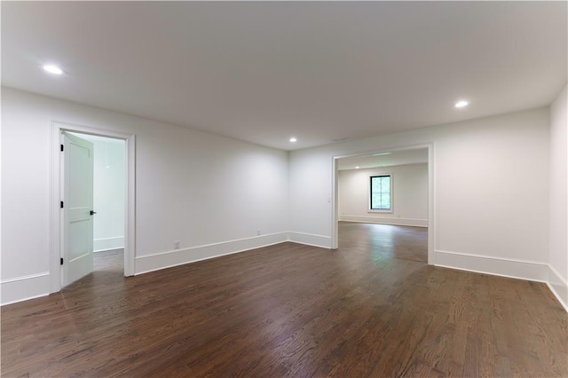 spare room with dark wood-type flooring