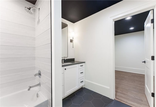 bathroom featuring vanity, shower / bathtub combination, and hardwood / wood-style floors