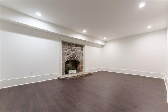 unfurnished living room with a fireplace and dark hardwood / wood-style floors