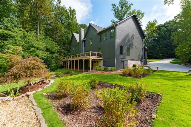 exterior space featuring a yard and a wooden deck