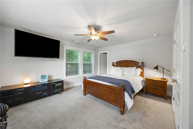 bedroom with baseboards, visible vents, ceiling fan, and light colored carpet