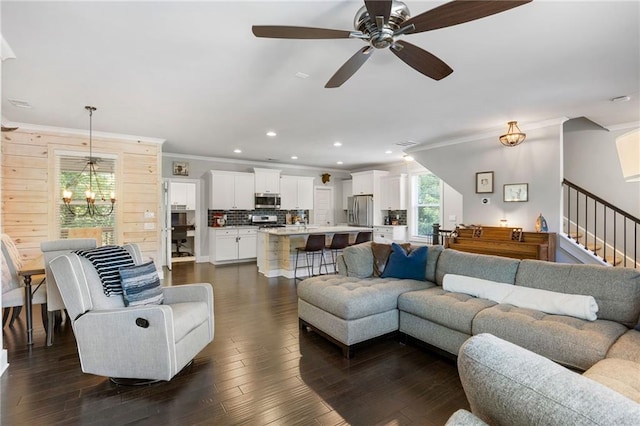 living room featuring stairs, ornamental molding, dark wood finished floors, and recessed lighting