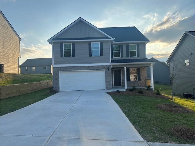 11045 Shadow Creek Ter, Hampton, GA 30228 - view of front of home with covered porch, concrete driveway, a garage, and a lawn
