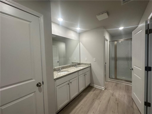 11045 Shadow Creek Ter, Hampton, GA 30228 - full bathroom with wood finished floors, double vanity, baseboards, and a shower stall
