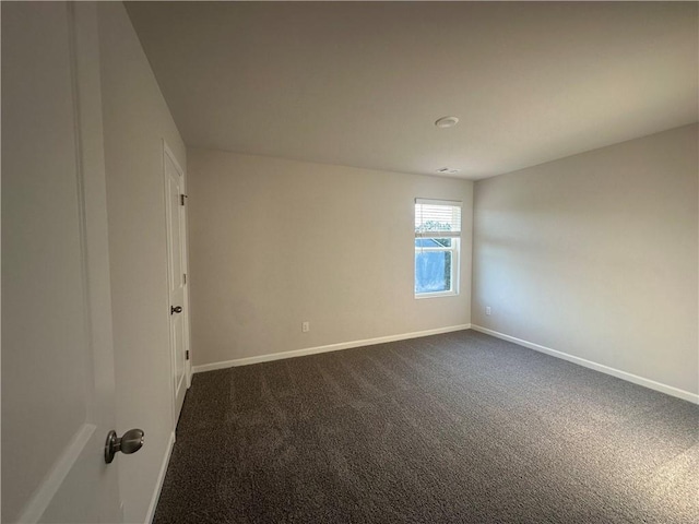 11045 Shadow Creek Ter, Hampton, GA 30228 - empty room featuring dark colored carpet and baseboards