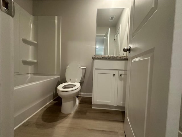 11045 Shadow Creek Ter, Hampton, GA 30228 - bathroom with wood finished floors, vanity, toilet, shower / washtub combination, and baseboards