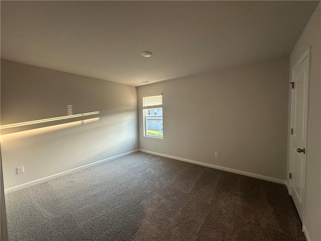 11045 Shadow Creek Ter, Hampton, GA 30228 - spare room featuring dark colored carpet and baseboards