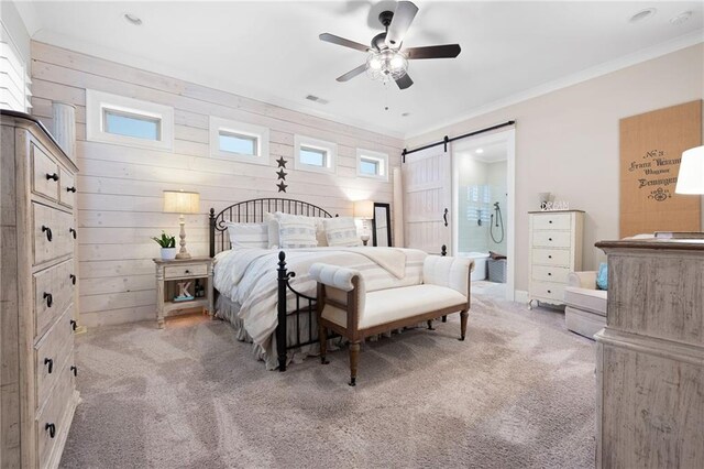 bedroom featuring a barn door, wood walls, carpet floors, and ornamental molding