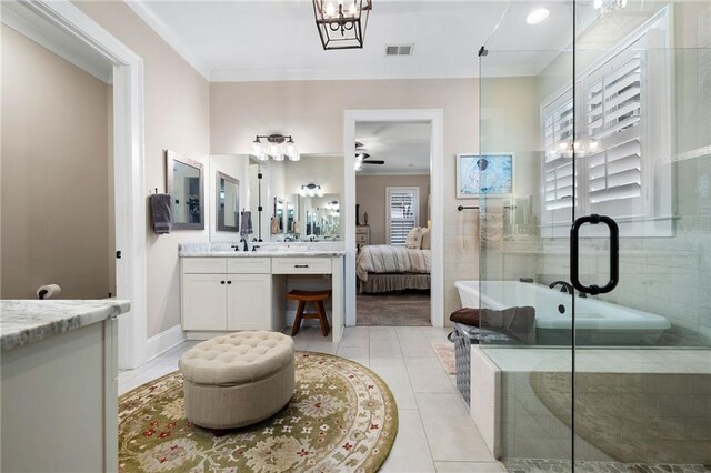 full bath featuring tile patterned floors, a freestanding tub, visible vents, ensuite bath, and vanity