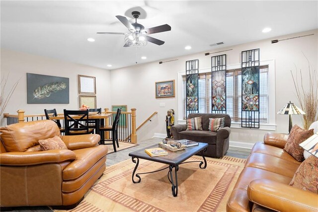 living area with visible vents, baseboards, recessed lighting, wood finished floors, and a ceiling fan