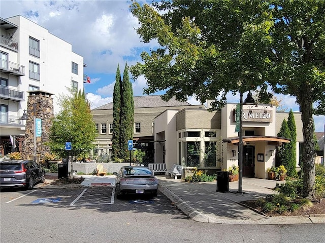 view of building exterior featuring uncovered parking