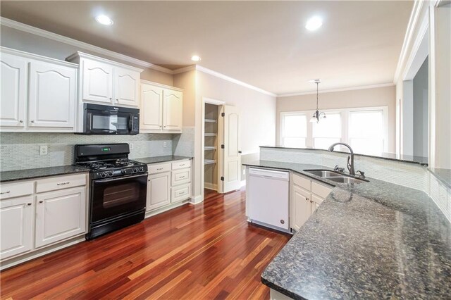 kitchen featuring white cabinets, black appliances, dark wood-type flooring, and sink