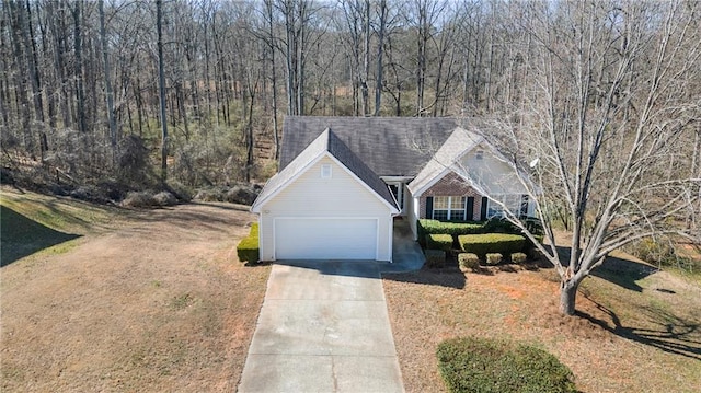 view of front of property featuring driveway, brick siding, an attached garage, and a front yard