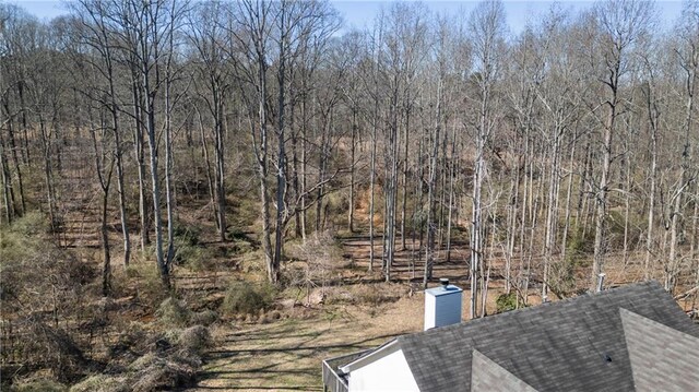 exterior space featuring a wooded view