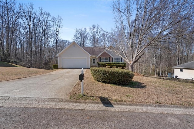 ranch-style home with a garage, driveway, and a front yard